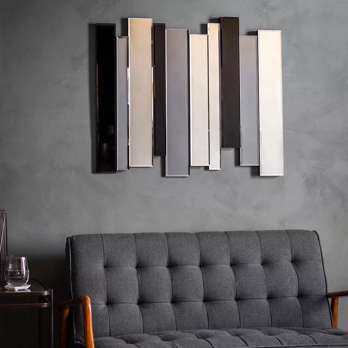Gallery Duval Art Deco grey smoked mirror with layered multi-tinted clear and black glass panels mounted vertically on a neutral hallway wall.