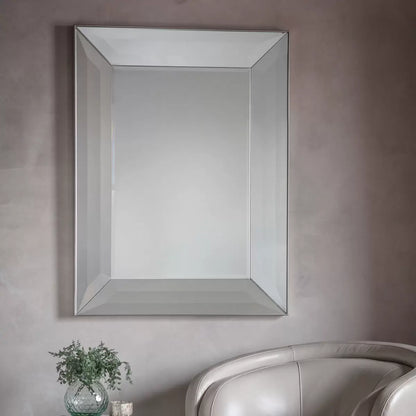 Gallery Ferrara rectangular mirror measuring 91 by 122 cm with a wide bevelled mirror frame and silver edge mounted horizontally above a neutral hallway console table.