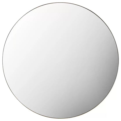 Large 100cm round wall mirror featuring a subtle champagne metal frame hanging in a brightly lit modern interior setting.