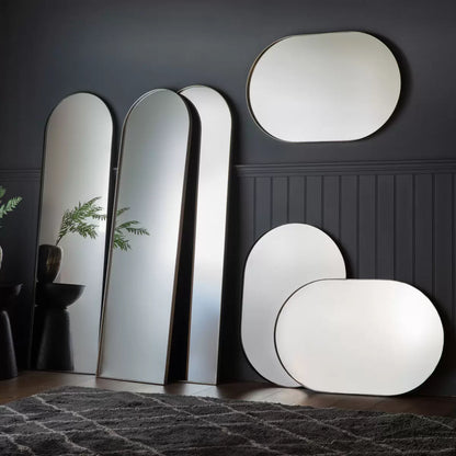 Front view of the Gallery Hurston Elipse Black Mirror showing its smooth curved iron frame and 60x90cm oval silhouette mounted on a minimalist wall.