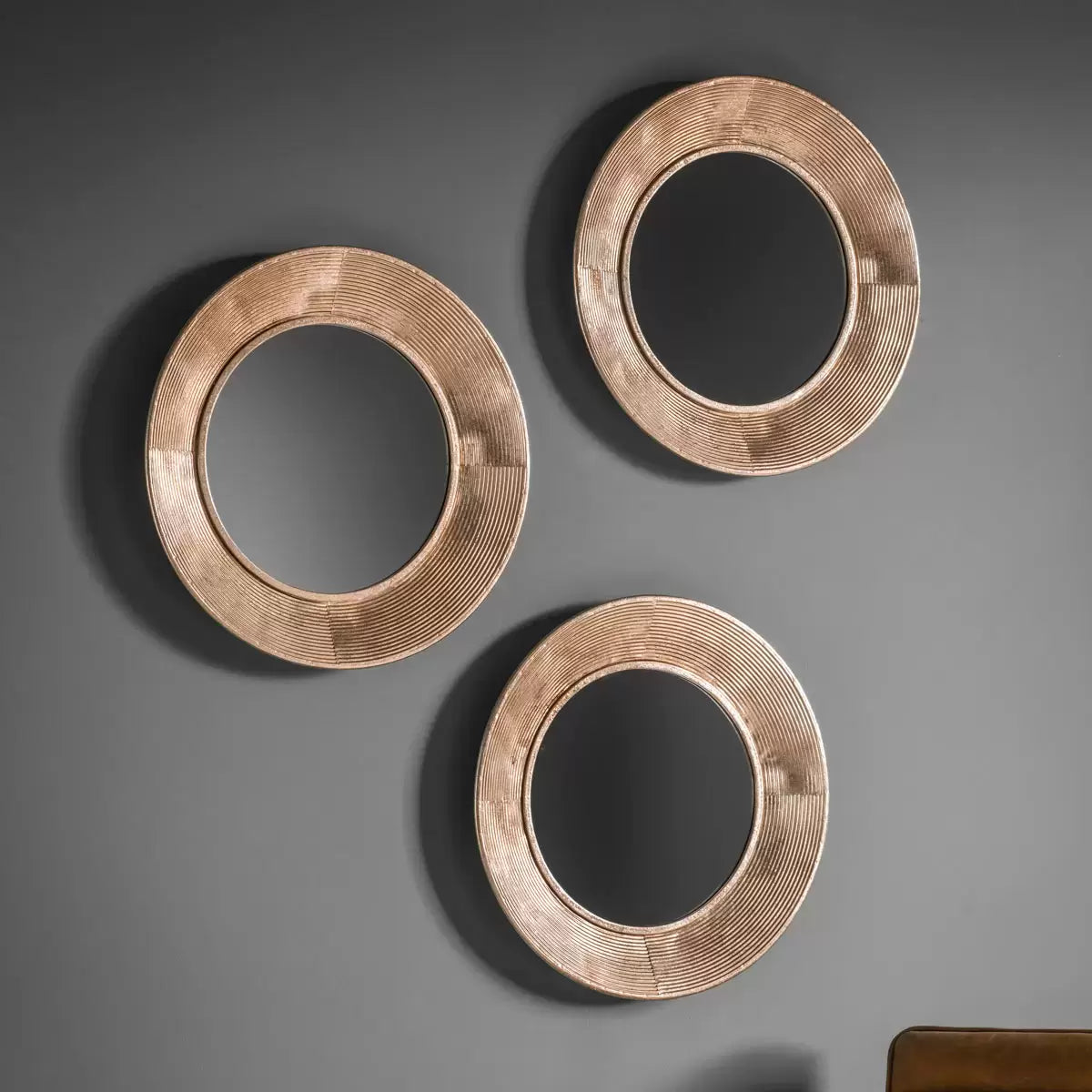 Gallery Knowle Mirror Trio set with slim black iron frames mounted on a textured interior wall reflecting warm daylight.
