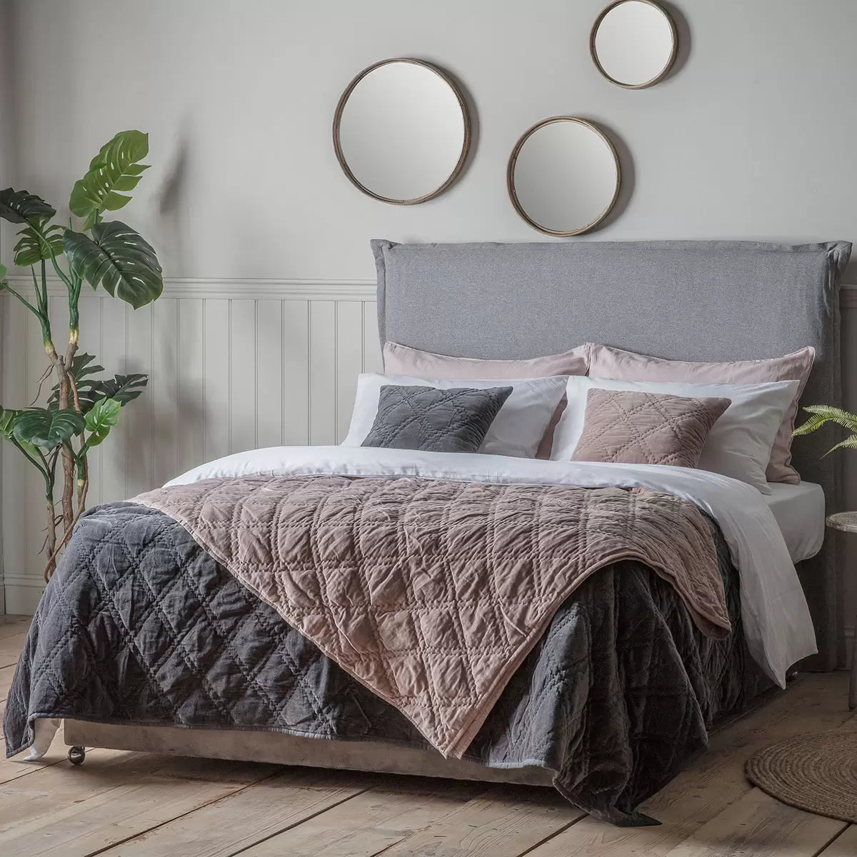 Oversized Gallery quilted cotton velvet bedspread in charcoal grey styled beautifully across a modern king size bed