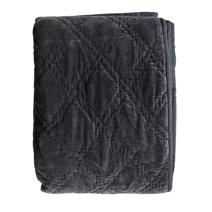 Oversized Gallery quilted cotton velvet bedspread in charcoal grey styled beautifully across a modern king size bed