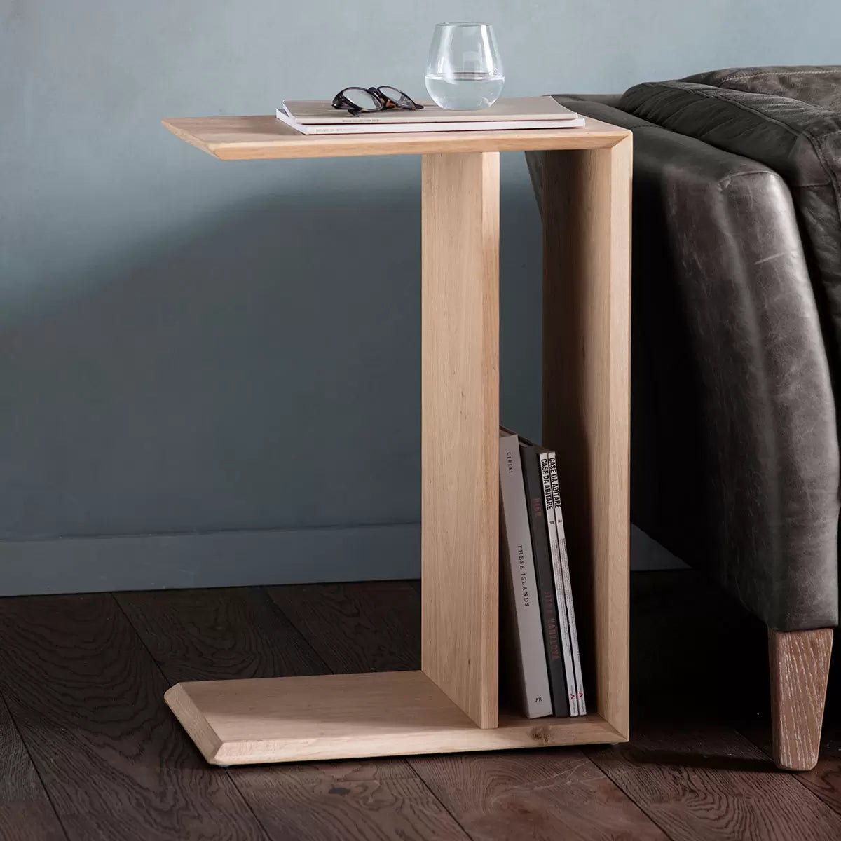 Gallery Milano Oak Sofa Table with natural oak finish positioned behind a modern sofa in a contemporary living room