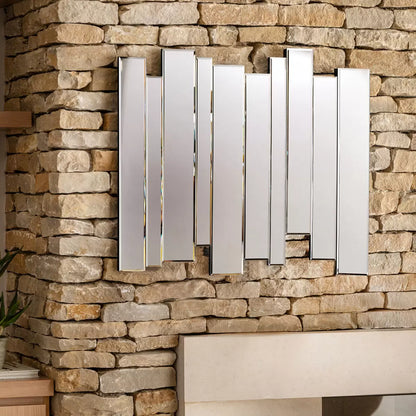 Front view of the Gallery Montessa 70 x 80cm wall mirror showing staggered bevelled glass panels mounted vertically on a neutral living room wall.