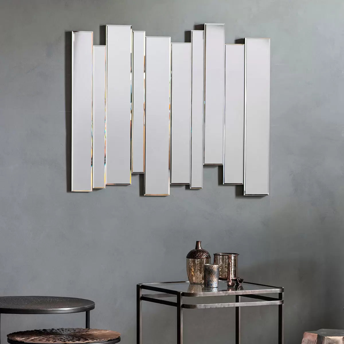 Front view of the Gallery Montessa 70 x 80cm wall mirror showing staggered bevelled glass panels mounted vertically on a neutral living room wall.