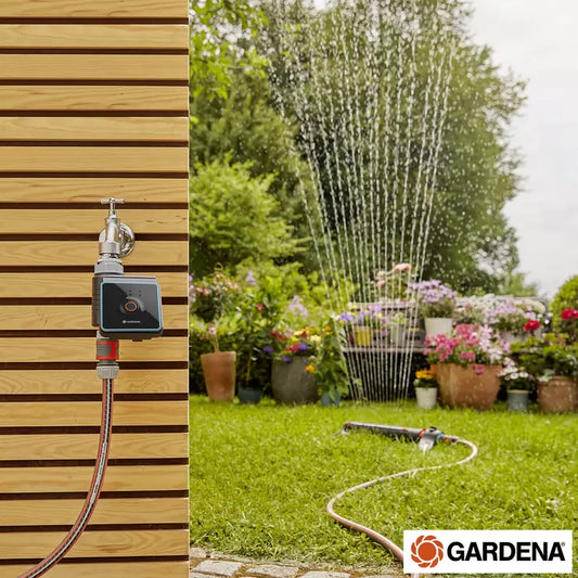 A Gardena Bluetooth Water Control unit attached to an outdoor garden tap, being programmed by a user via a smartphone.