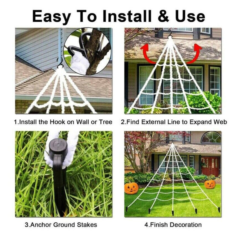 Large white 5M giant spider web stretched from a house roofline down to a grass lawn secured with ground stakes.
