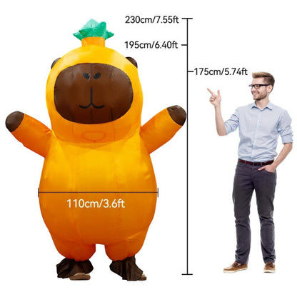 A person wearing a giant, light brown inflatable capybara costume with a smooth waterproof texture, standing outdoors on green grass ready for a party.