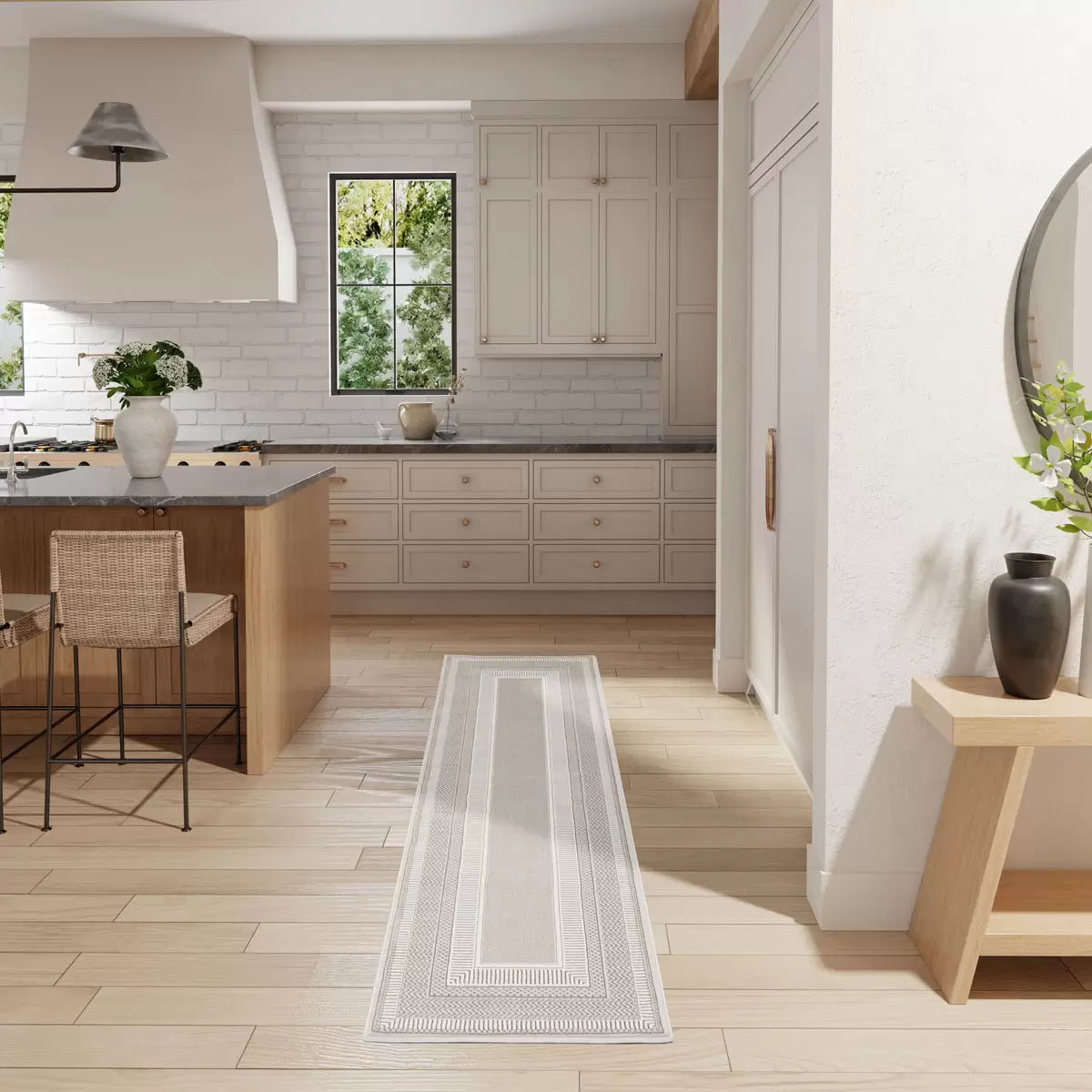 Angle view of the ivory and cream Glitz Border Runner on dark hardwood floor highlighting its metallic shimmer and raised geometric border.