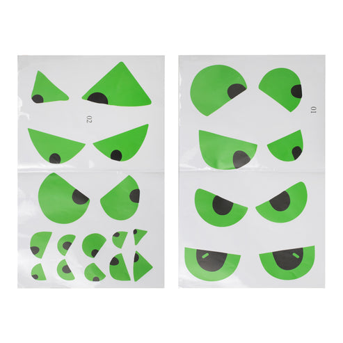Sheet of 12 green glow in the dark spooky eye stickers arranged on a dark wooden interior door in low lighting.