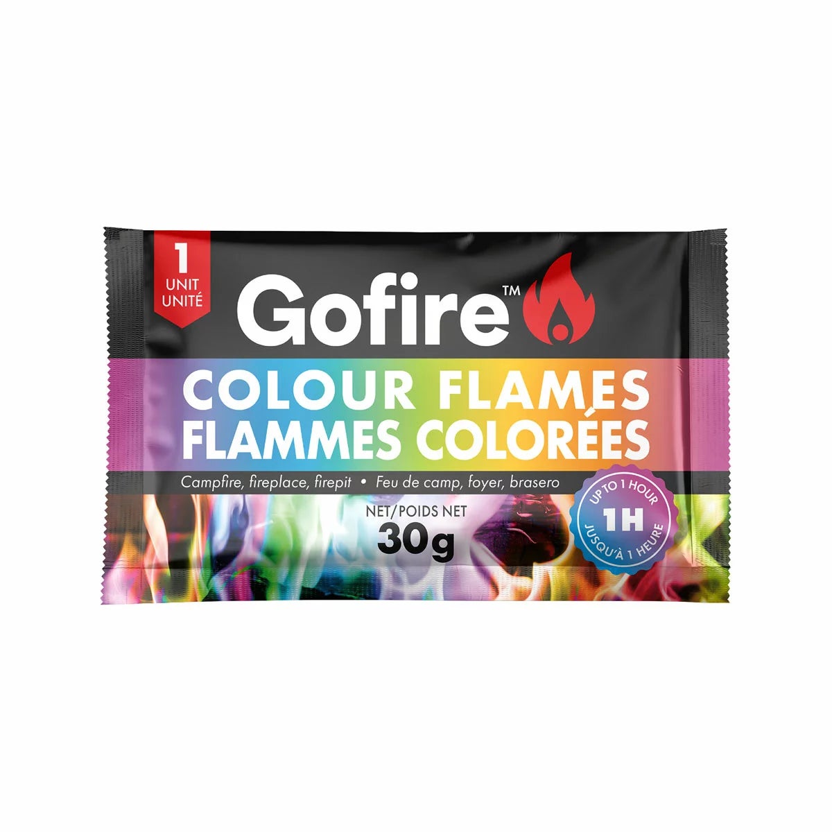 A 25 pack tube of GoFire Colour Flames sitting next to a roaring backyard fire pit displaying vibrant blue and green flames.