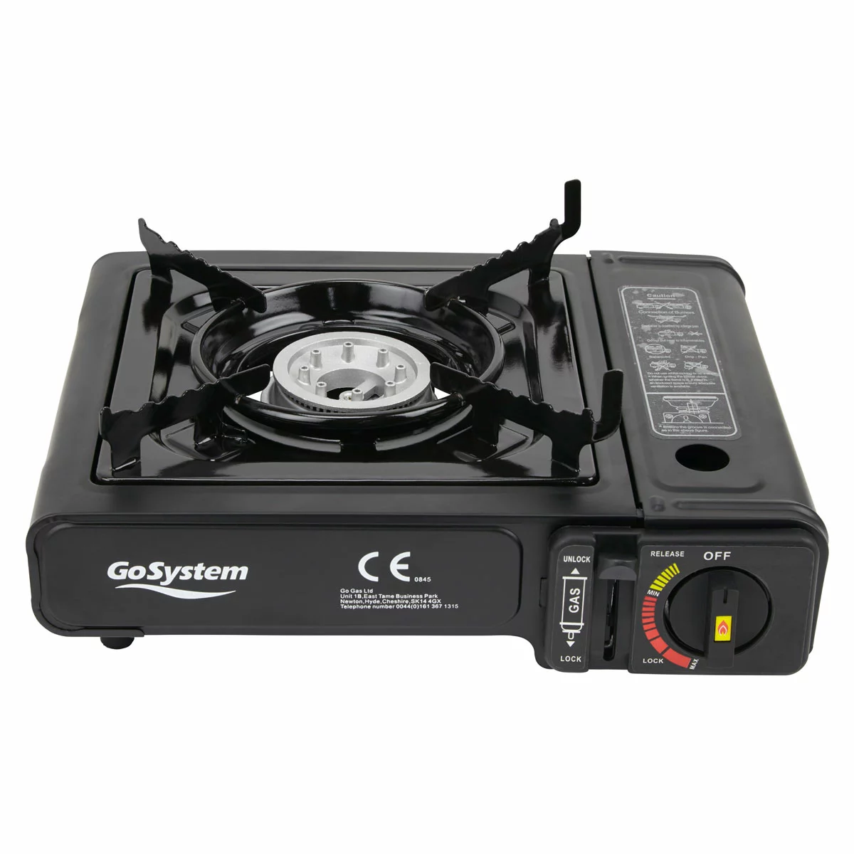 Compact black metal GoSystem Dynasty Compact II single-burner stove with serrated pan supports sitting on a wooden picnic bench next to its hardshell carrying case.