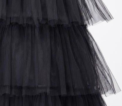 Front angle shot of a child sized 5-6 wearing a floor-length black gothic queen dress with lace bell sleeves and ruffled skirts.