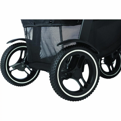 Graco Evo XT stroller in profile showing the extended wheelbase, multi-terrain tires, and protective mudguards on a rugged trail.