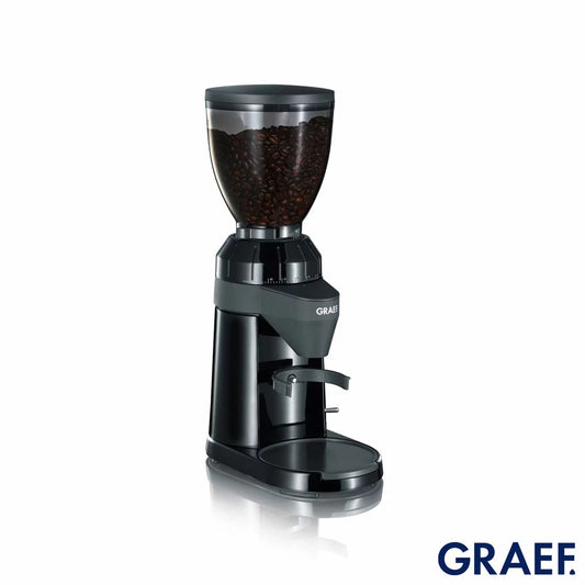 Front view of the black Graef CM802UKI Conical Burr Coffee Grinder with bean hopper attached and portafilter cradle mounted on a kitchen counter.