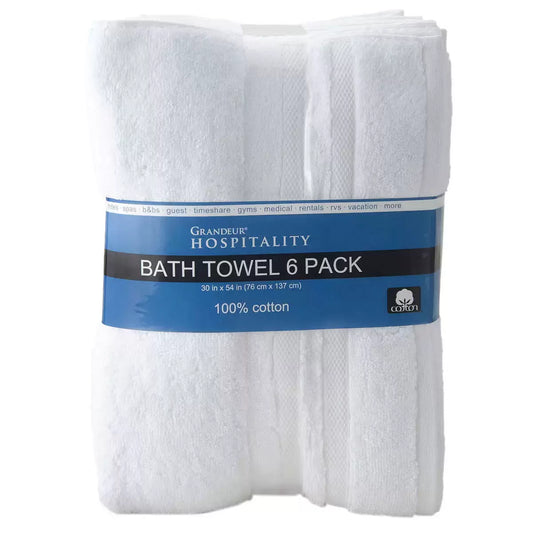 A stack of six crisp white Grandeur hospitality bath towels showing the textured cotton weave and reinforced borders.