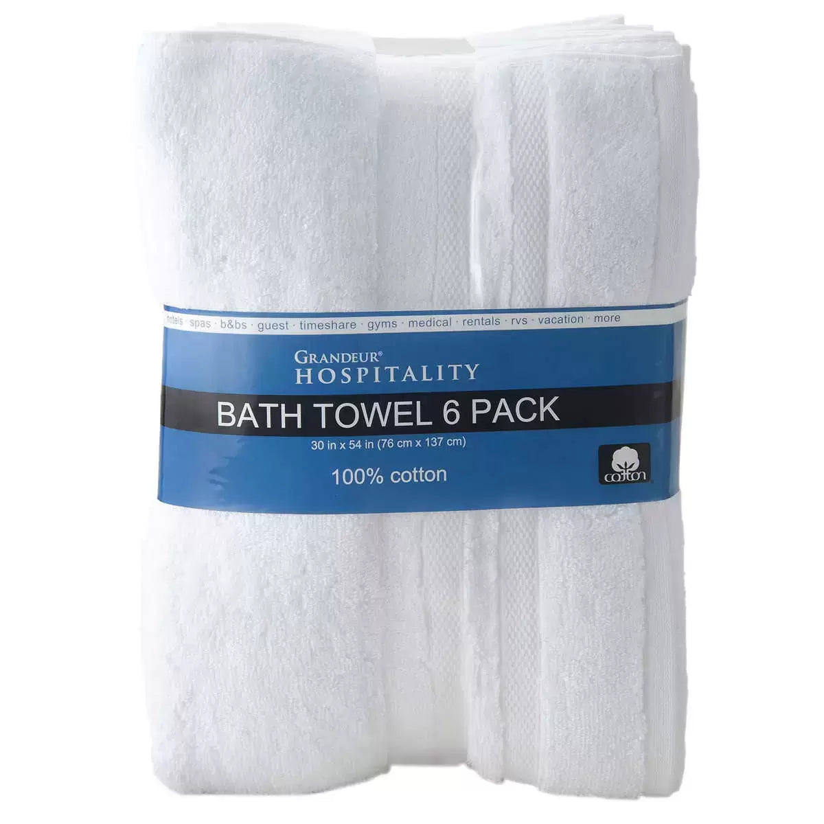 Six neatly stacked Grandeur crisp white 100% cotton bath towels showcasing double-stitched finished hems on a wooden shelf.