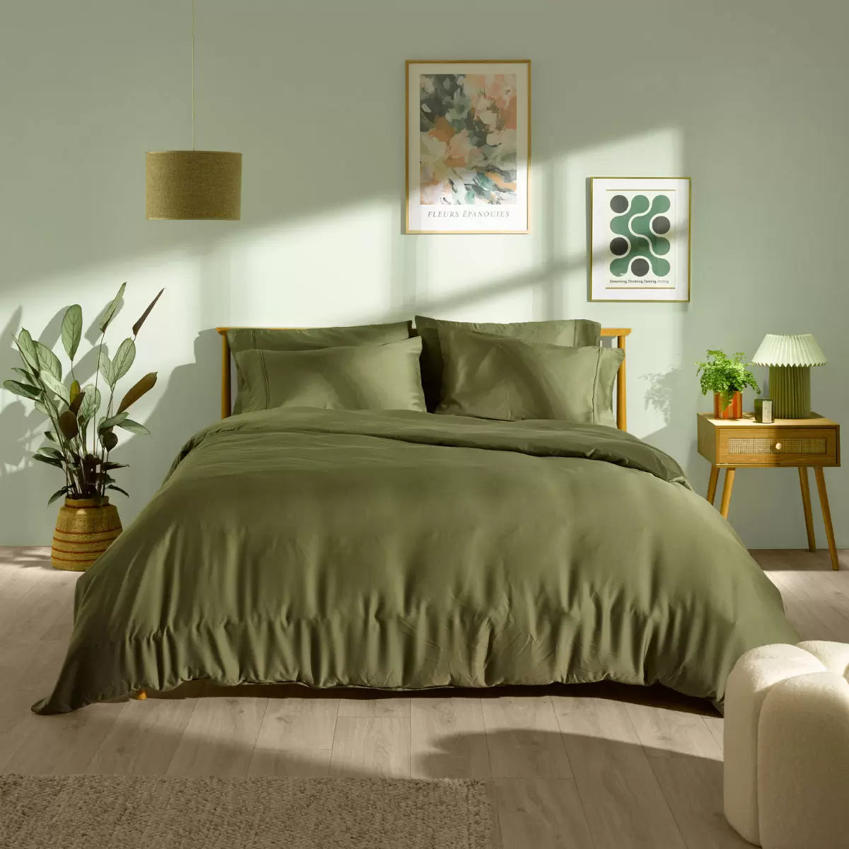 Panda Signature+ green bamboo lyocell bedding set draped smoothly on a bed highlighting silky satin weave finish, fitted sheet, and matching pillowcases.