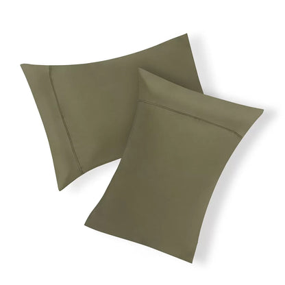 Panda Signature+ green bamboo lyocell bedding set draped smoothly on a bed highlighting silky satin weave finish, fitted sheet, and matching pillowcases.