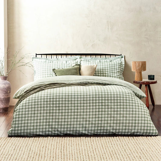 A close-up view of the single sage green and cream gingham cotton duvet cover showing the fabric's soft woven texture and a neat Oxford-bordered pillowcase.