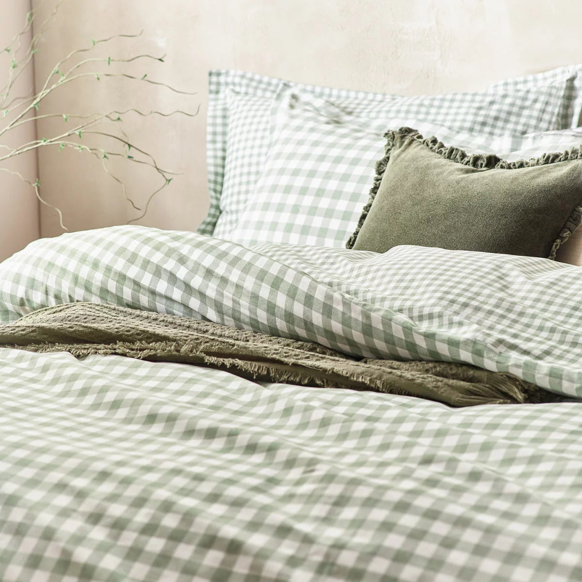 A close-up view of the single sage green and cream gingham cotton duvet cover showing the fabric's soft woven texture and a neat Oxford-bordered pillowcase.