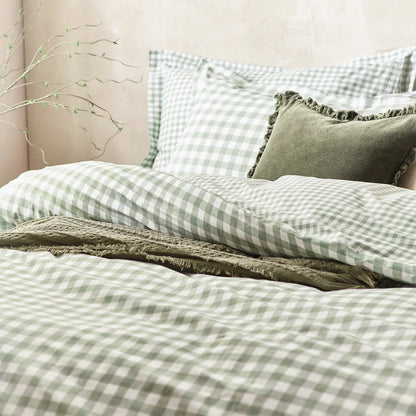 A close-up view of the single sage green and cream gingham cotton duvet cover showing the fabric's soft woven texture and a neat Oxford-bordered pillowcase.