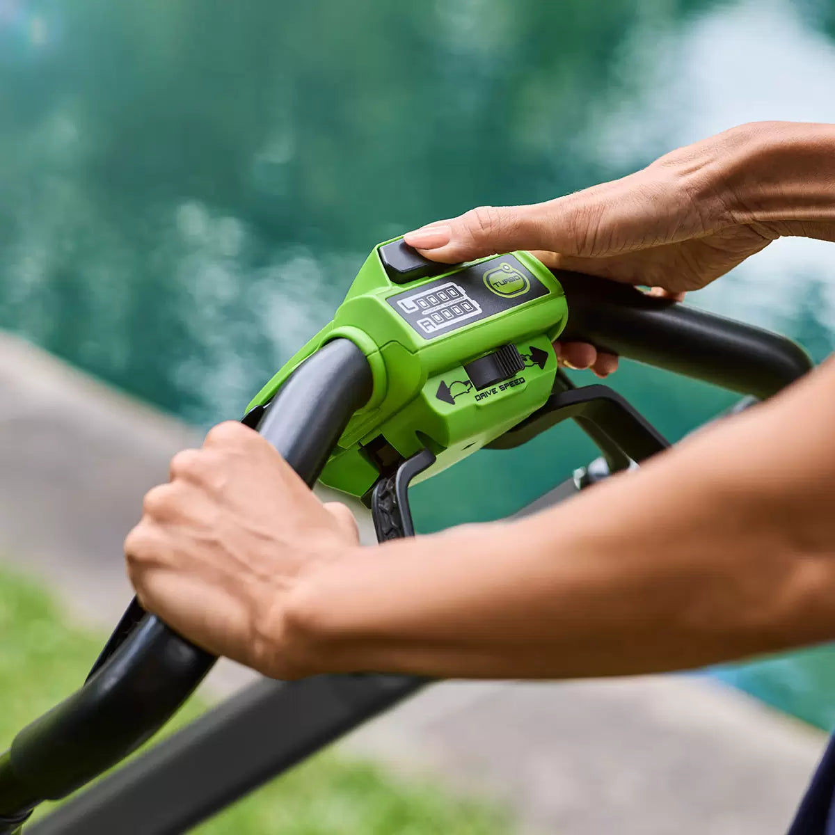 Greenworks 48V self-propelled cordless lawn mower with 46cm cutting deck mowing a large residential garden