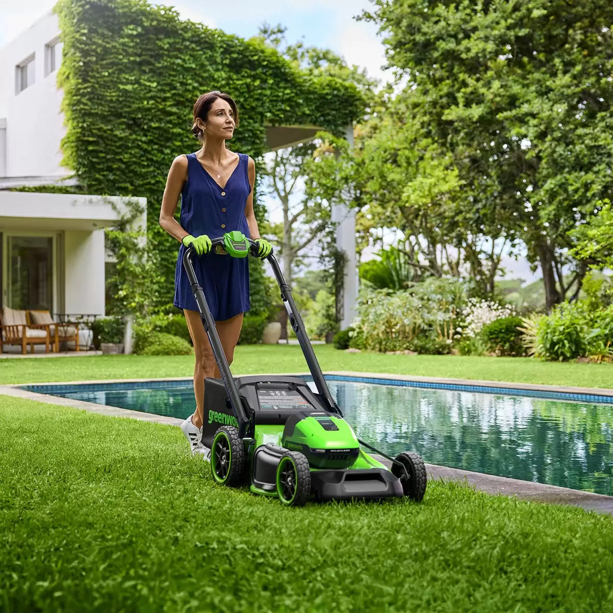 Greenworks 48V self-propelled cordless lawn mower with 46cm cutting deck mowing a large residential garden