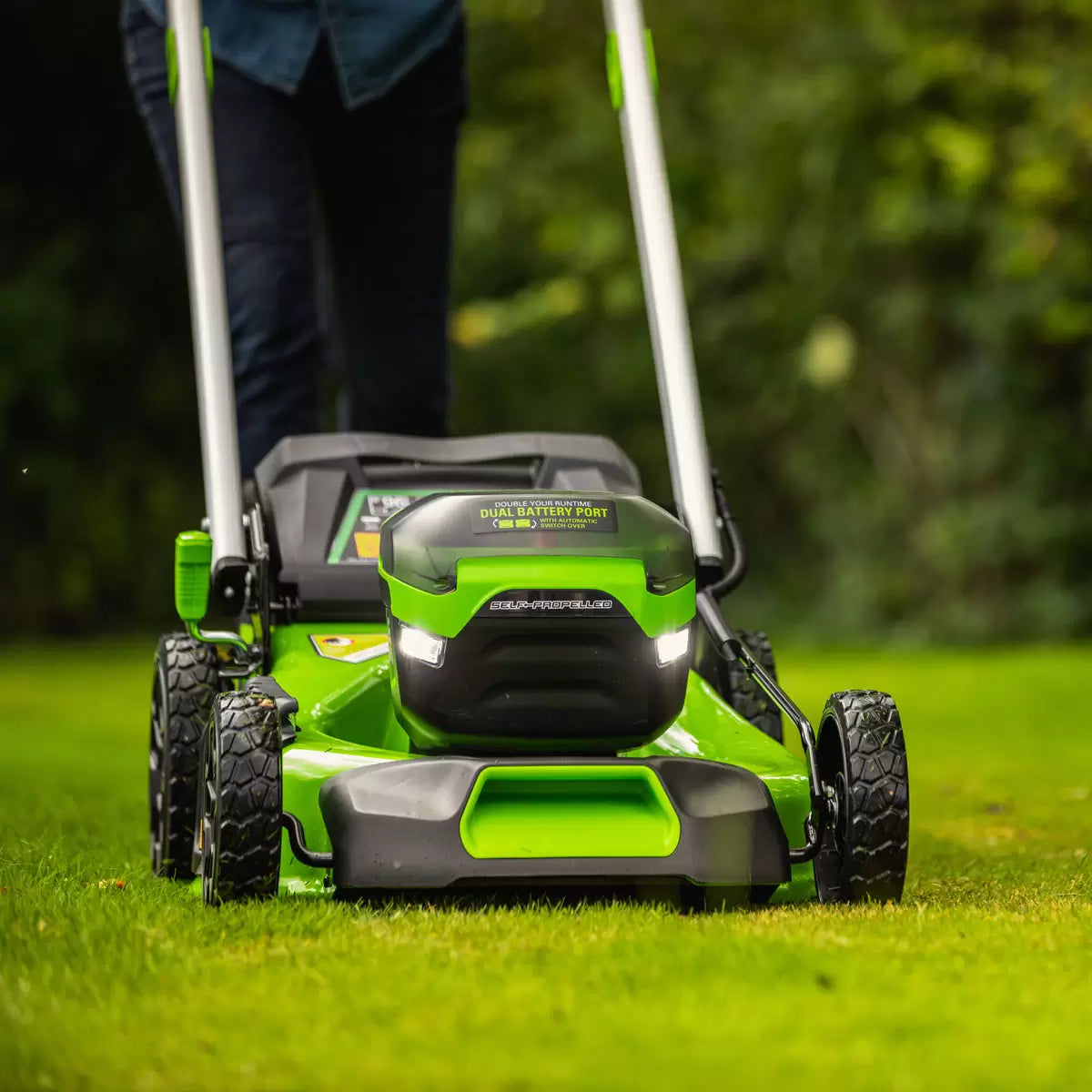 Greenworks 60V 46cm self-propelled cordless lawnmower with 4Ah battery mowing a large residential garden