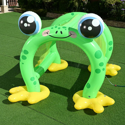 Giant green inflatable frog-shaped sprinkler arch tunnel spraying water onto a green garden lawn during sunny outdoor play.