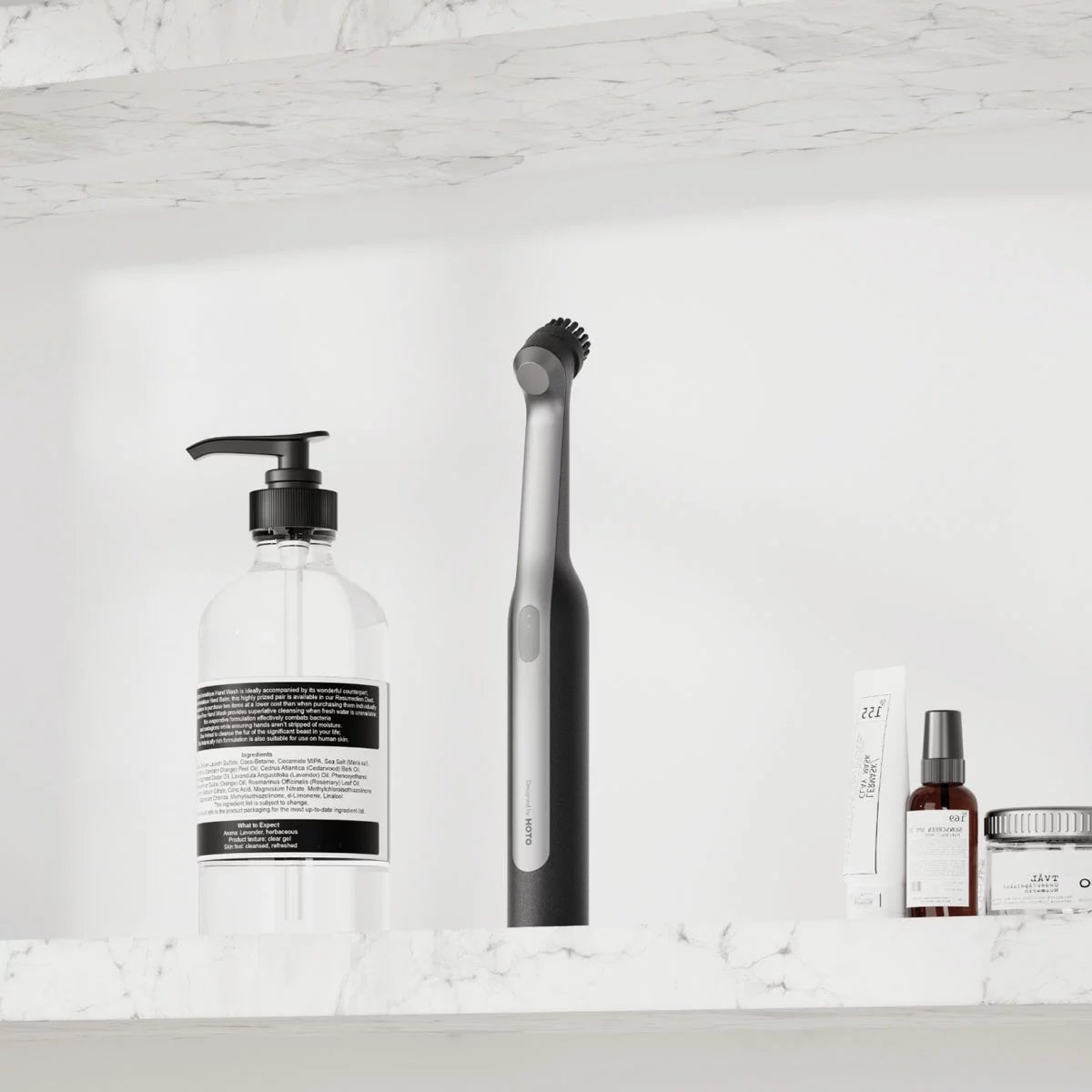 Close-up angle of the white HOTO Wand Cordless Spin Scrubber with magnetic brush head attached in a modern tiled bathroom setting.