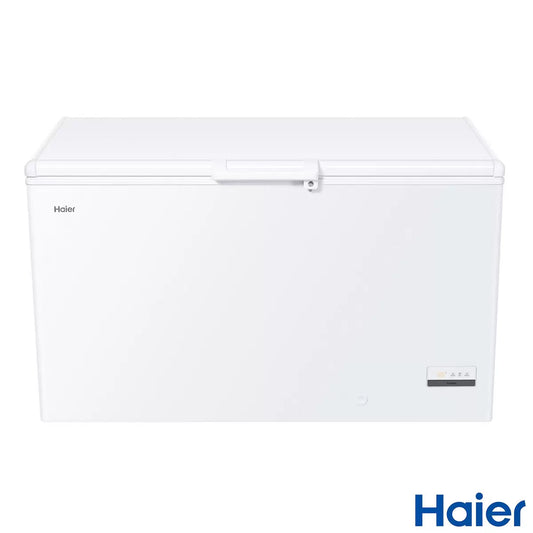 Haier HCE321DK white chest freezer with open lid revealing spacious 319L interior lit by LED light in a clean home utility setting