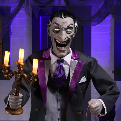 Full-length shot of a 6ft tall animated Halloween butler prop in a black suit holding an illuminated candelabra on a foggy front porch at dusk.