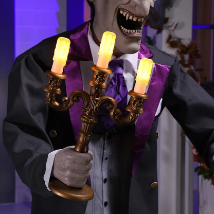 Full-length shot of a 6ft tall animated Halloween butler prop in a black suit holding an illuminated candelabra on a foggy front porch at dusk.