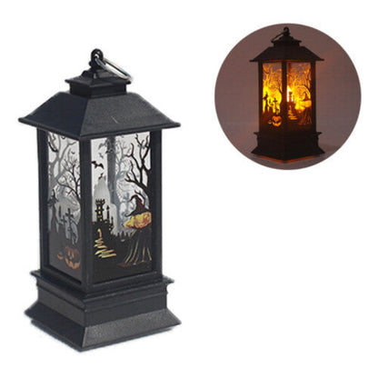 A black Gothic Halloween lantern featuring pumpkin and bat cutout designs, glowing with a warm flickering light on a dark wooden table.