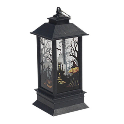 A black Gothic Halloween lantern featuring pumpkin and bat cutout designs, glowing with a warm flickering light on a dark wooden table.