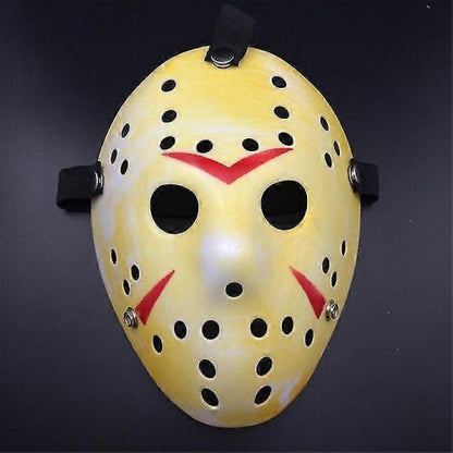 Front view of an iconic white and red painted Jason Voorhees Friday the 13th scary hollow out plastic mask on a dark background.