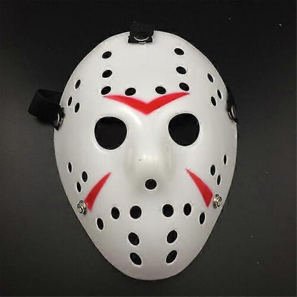 Front view of an iconic white and red painted Jason Voorhees Friday the 13th scary hollow out plastic mask on a dark background.