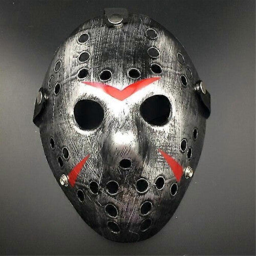 Front view of an iconic white and red painted Jason Voorhees Friday the 13th scary hollow out plastic mask on a dark background.