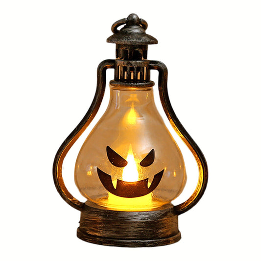 A high-brightness Halloween LED smiley face lantern hanging by its hook and glowing softly on a decorated tabletop.
