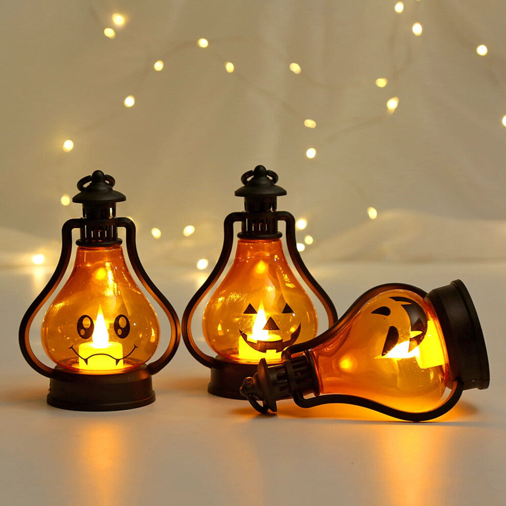 A high-brightness Halloween LED smiley face lantern hanging by its hook and glowing softly on a decorated tabletop.