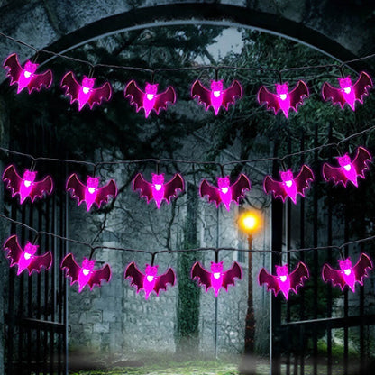 A 19.7ft multi-color Halloween string light featuring pumpkin, bat, and ghost motifs glowing brightly along an outdoor porch railing.