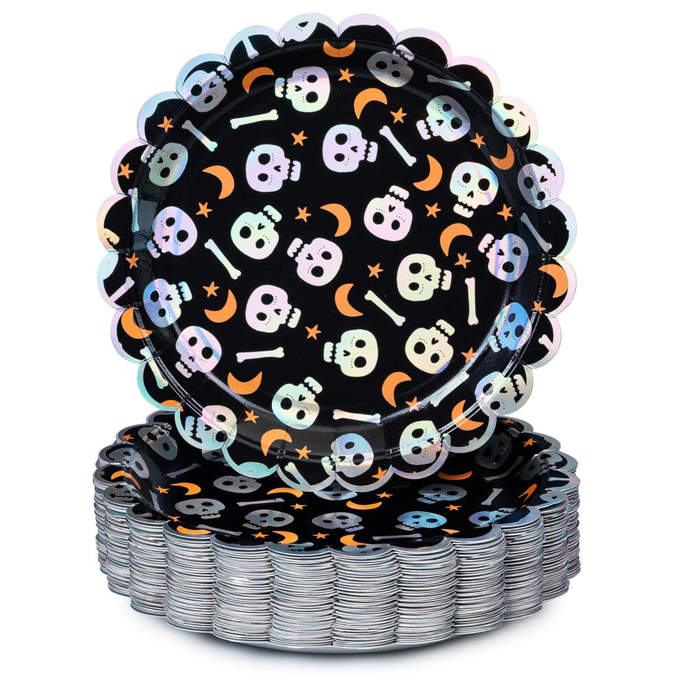 Stack of 50 scalloped edge Halloween paper plates featuring iridescent silver foil skull patterns on a dark wooden table setting.