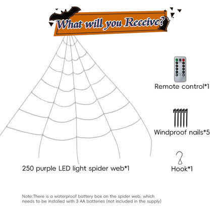 Giant 16-foot purple LED illuminated spider web drapes down a front yard lawn staked into ground at dusk.