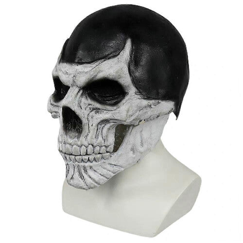 Front view of a full-head black skull costume mask with a realistic articulated moving jaw against a dark studio background.