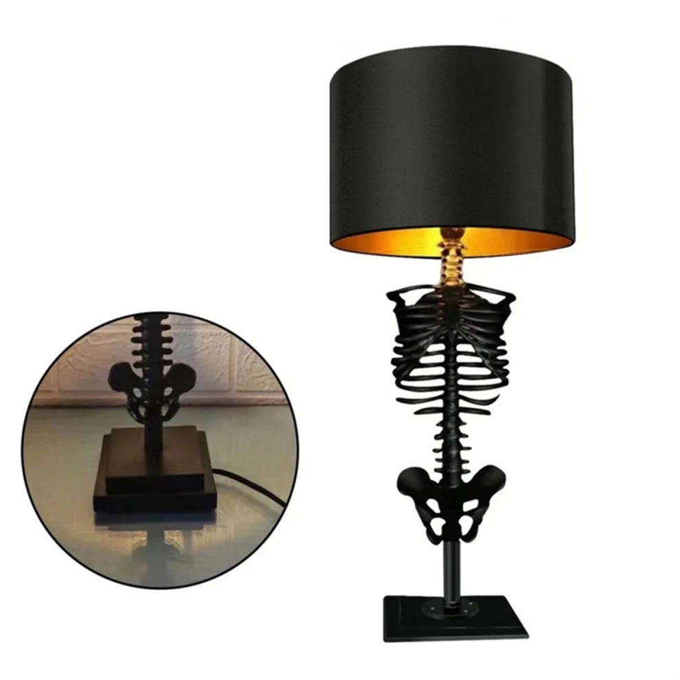 A Gothic resin skull desktop ambient light glowing on a dark workspace surface for Halloween party decoration.