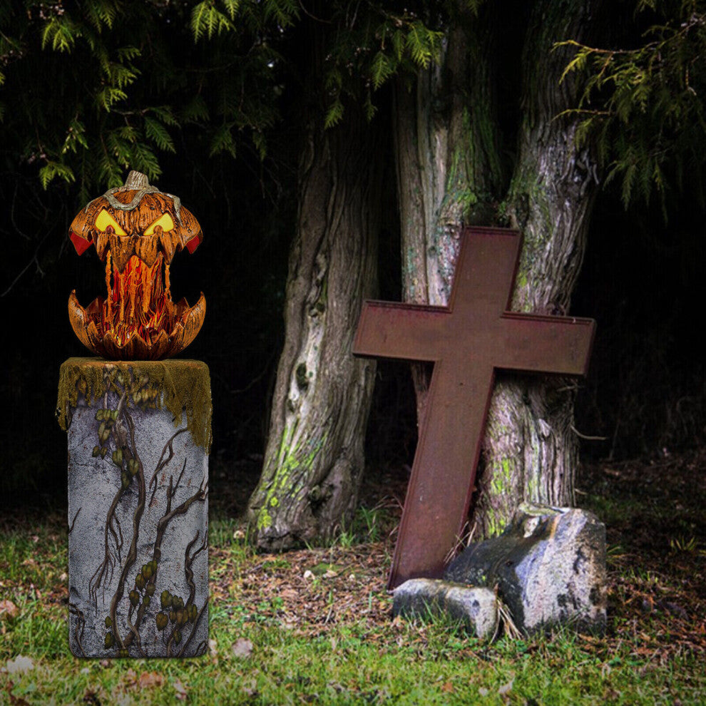 An illuminated Halloween talking animated pumpkin head projector speaker decor glowing on a dark table, showcasing its carved face and festive design.