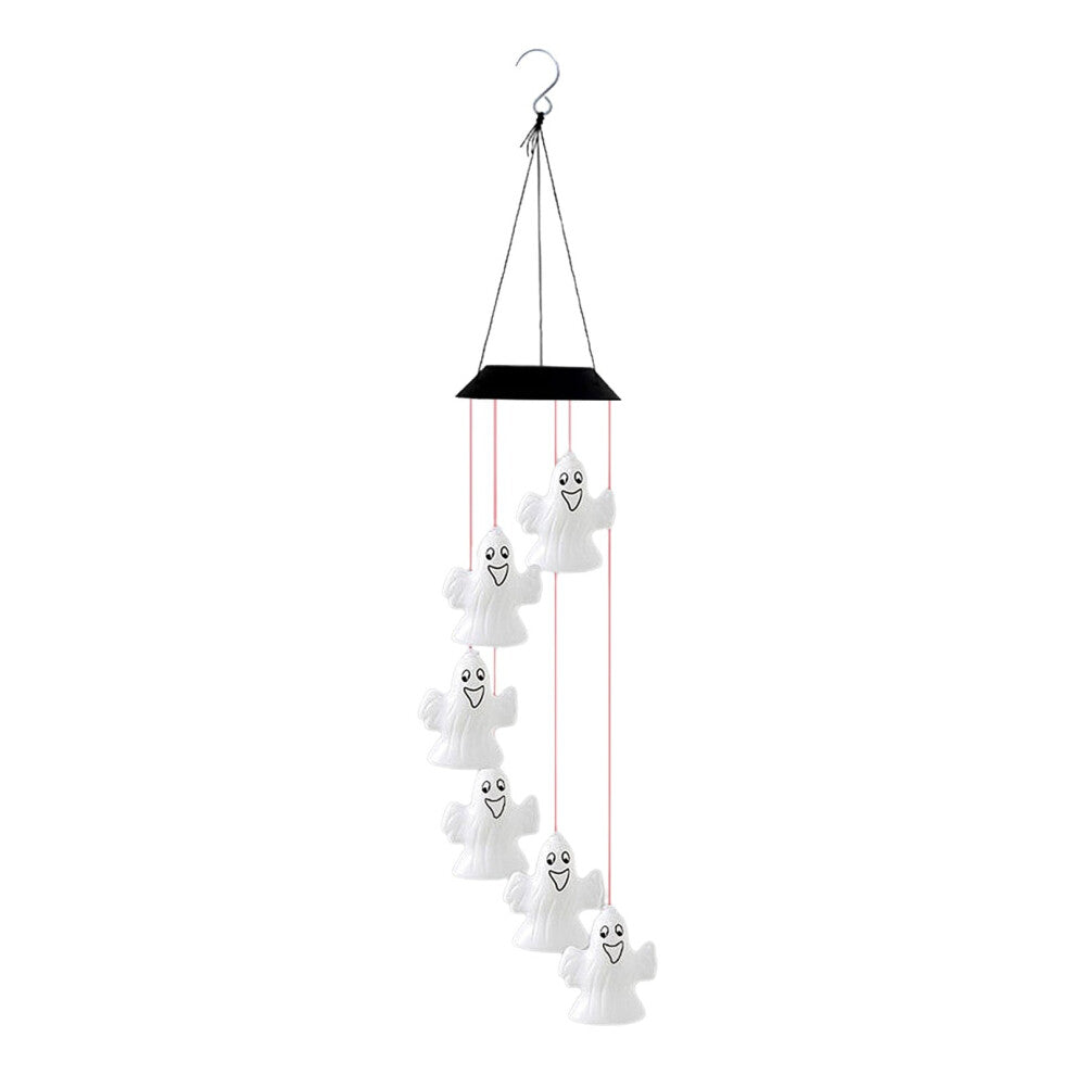 A colorful solar-powered Halloween wind chime lantern hanging from an outdoor porch ceiling, glowing with slow-flashing multi-color LEDs.