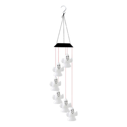A colorful solar-powered Halloween wind chime lantern hanging from an outdoor porch ceiling, glowing with slow-flashing multi-color LEDs.
